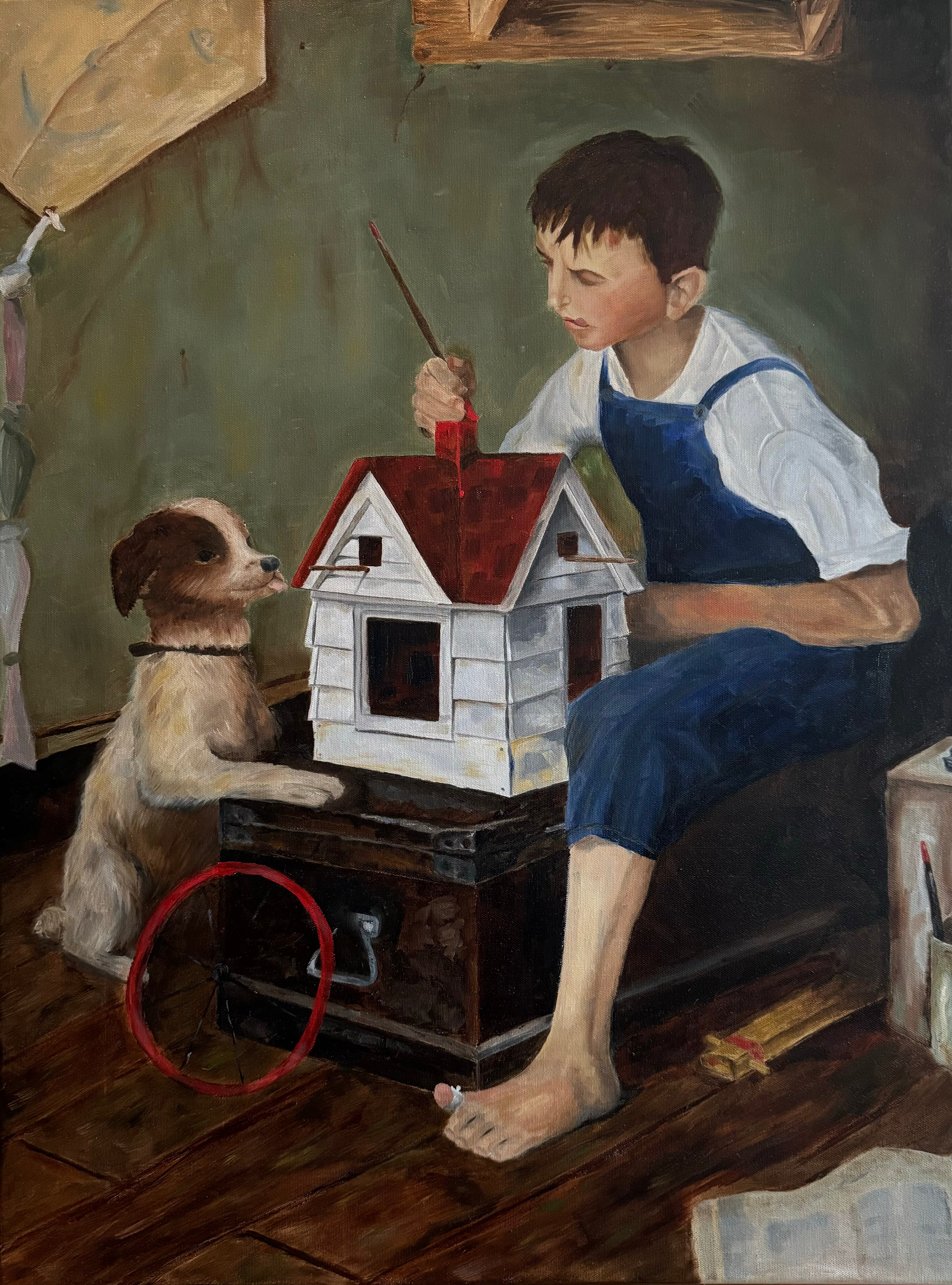 Boy paints small wooden house with dog